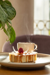airy dessert decorated with raspberries, served with tea, dessert in the interior