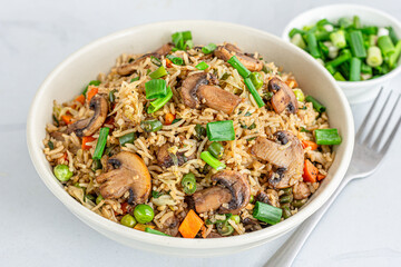 Asian Vegetable and Mushroom Fried Rice in a Bowl on White Background