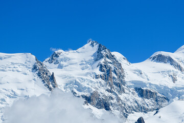 Naklejka premium Snow capped Mont Maudit in the Mont Blanc Massif in Europe, France, the Alps, towards Chamonix, in summer on a sunny day.