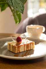 airy dessert decorated with raspberries, served with tea, dessert in the interior