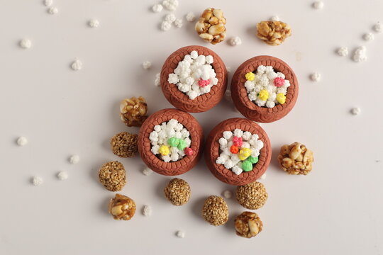 Indian festival makar sankranti concept : Tilgul in small bowl. Tilgul is a colourful sesame candy coated with sesame seeds; in Maharashtra people exchange tilgul on Sankranti