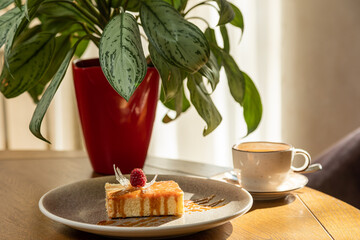 airy dessert decorated with raspberries, served with tea, dessert in the interior