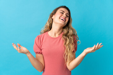 Fototapeta premium Young Brazilian woman isolated on blue background smiling a lot