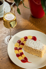 delicious dessert napolon served with champagne. photo of dessert in the interior.
