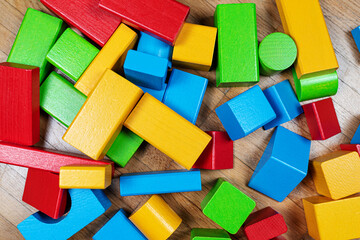 above view of colorful wooden toy blocks on hardwood floor