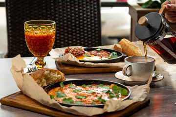 breakfast of omelet, eggs fried with bacon. Served with fresh pastries and drinks