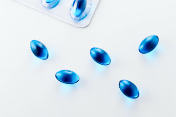 Blue Gel Capsules of Ibuprofen on white background
