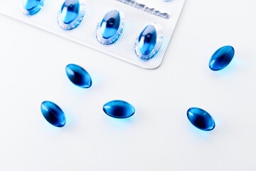 Blue Gel Capsules of Ibuprofen on white background