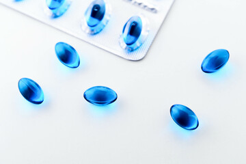 Blue Ibuprofen painkiller caps on white background