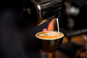 Hand on Barista making latte cafe, Cup of coffee with beautiful Latte art on white cup