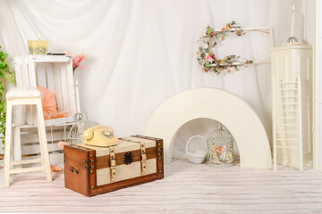 Obraz premium Spring decor romantic with telephone, trunk, candles, flowers and accessories and white cloth in studio.