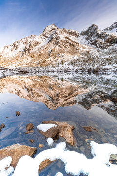 Corna Nera mountain peak reflected in Rogneda lake during the autumn sunrise, Rhaetian Alps, Sondrio, Lombardy, Italy