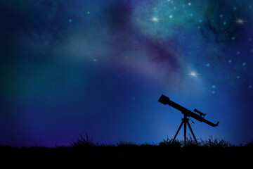 Silhouette of a telescope in the ground against a stars filled night sky