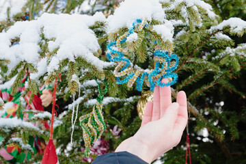 Christmas tree toy on a snowy branch