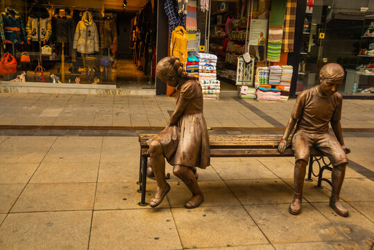 MARMARIS, TURKEY: A modern monument of a girl and a boy on a bench on the street in Marmaris.
