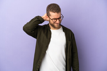 Young handsome caucasian man isolated on purple background with neckache