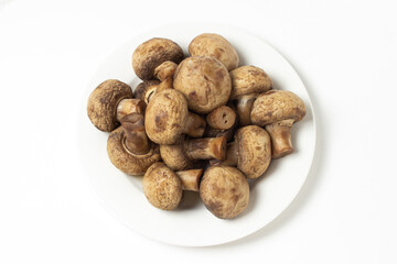 Boiled mushrooms on a white background. Boiled champignons on a white plate. Healthy diet