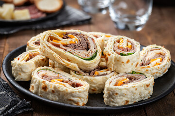 Tortilla wraps on a black plate
