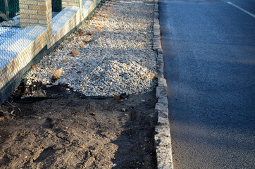 delivery of gray river pebbles like mulch to flower beds in the garden using a wheelbarow from the...