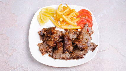 Portion beef doner kebab with french fries isolated