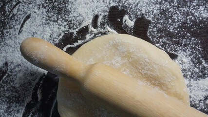 cooking process, modeling, recipe, dough, roll out with a wooden rolling pin, flour