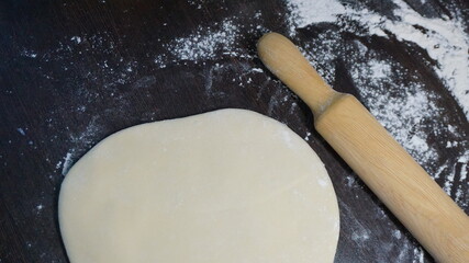 cooking process, modeling, recipe, dough, roll out with a wooden rolling pin, flour