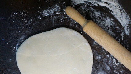 cooking process, modeling, recipe, dough, roll out with a wooden rolling pin, flour