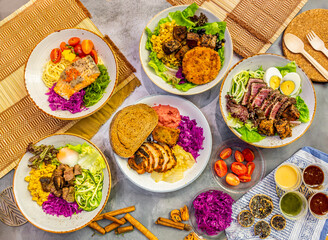 Turkish colorful food set. Turkish foo set. baked salmon pasta, tuna tataki salad, Turkish platter, vegan bowl, in marble background top view of Turkish food table