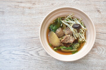 braised beef meat with bean sprout topping mushroom in brown soup on bowl