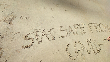 Write text letters on the sandy beach.