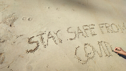 Write text letters on the sandy beach.