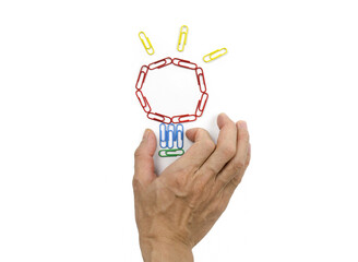 Colorful paper clips,hand and Light bulb on white background.Concept of idea.