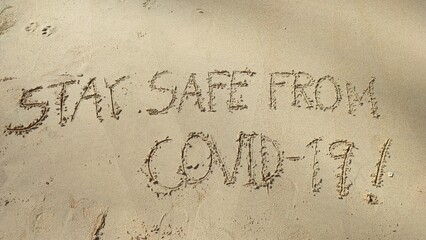 Write text letters on the sandy beach.