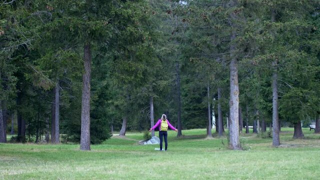 Girl with open arms feels the energy of nature. Mountain forest. Video 4K