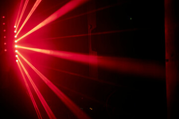 Bright red neon laser lights illuminate the darkness creating lines and triangle shapes in sci-fi...