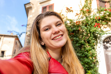 Young woman traveling to Rome. Selfie of a smiling young blond woman. Travel and freedom concept.