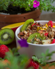 Tropical Salad of Fruits with mango, strawberry, kiwi, melon and granola