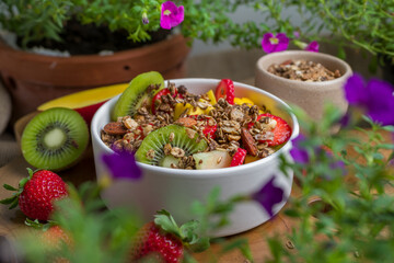 Tropical Salad of Fruits with mango, strawberry, kiwi, melon and granola