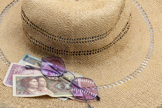 Straw hat, vibrant glasses and Indian Rupee