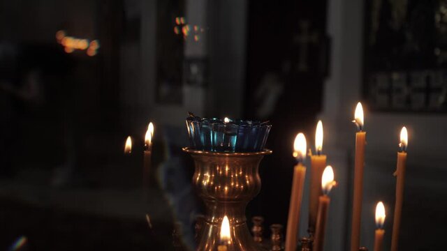 Burning candles in the church church. Close-up. High quality FullHD footage