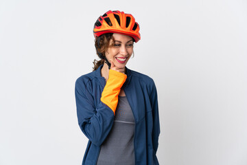 Young cyclist woman isolated on white background looking to the side and smiling