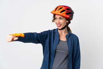 Young cyclist woman isolated on white background giving a thumbs up gesture