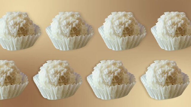 two lines with many rafaello candy animated in different direction  on a natural beige background. Sweet food concept. Love template for mother's day and valentine's day.
