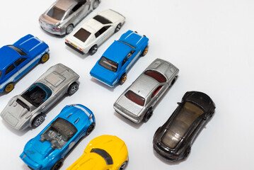 Colorful miniature toy car collection on light background selective focus.