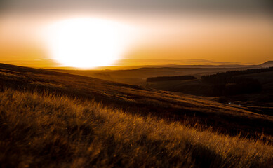 Fototapeta na wymiar Sunset across moorland in Yorkshire orange tones.