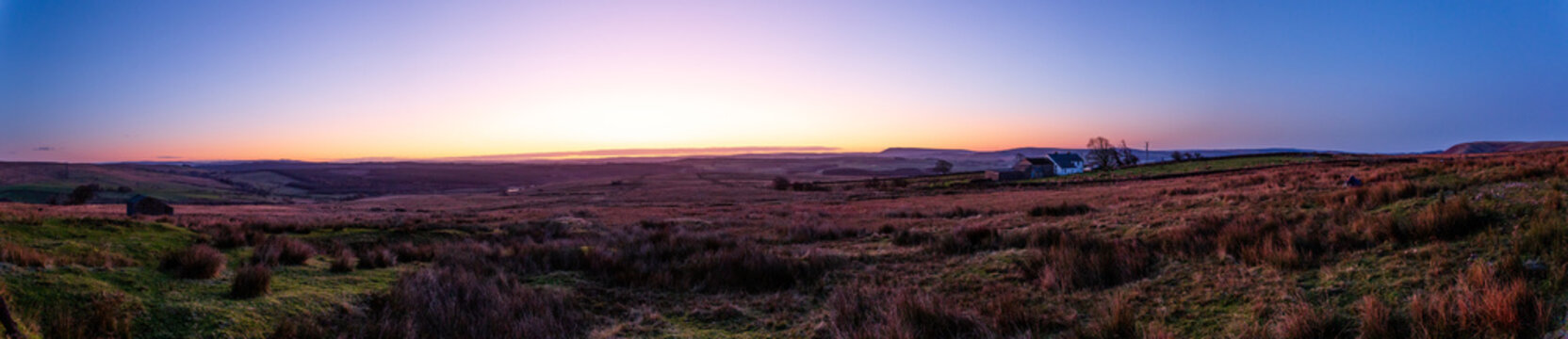 Sunrise across a moor in Yorkshire, with purple and orange tones.