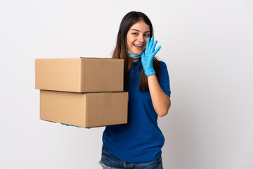 Young delivery woman protecting from the coronavirus with a mask isolated on white background shouting with mouth wide open