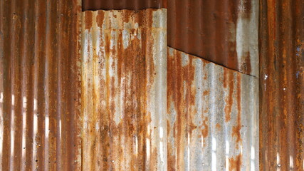 Rusted zinc wall background. The abstract texture of the vintage rustic style galvanized metal wall is sunny. Selective focus