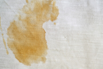 white fabric with coffee stain and wrinkles