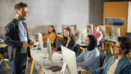 Teacher Giving Lesson to Diverse Multiethnic Group of Female and Male Students in College Room, Learning New Academic Skills on a Computer. Lecturer Shares Knowledge with Smart Young Scholars.